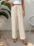Cream drawstring wide-leg pants with elastic waist and relaxed, straight legs