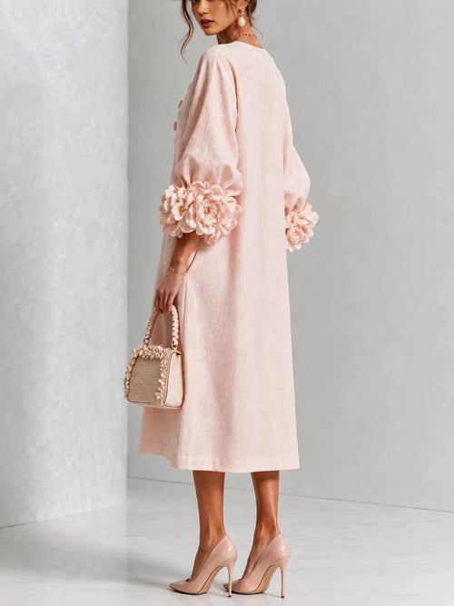 Blush pink midi dress with round neck and vertical button placket, floral puff cuffs