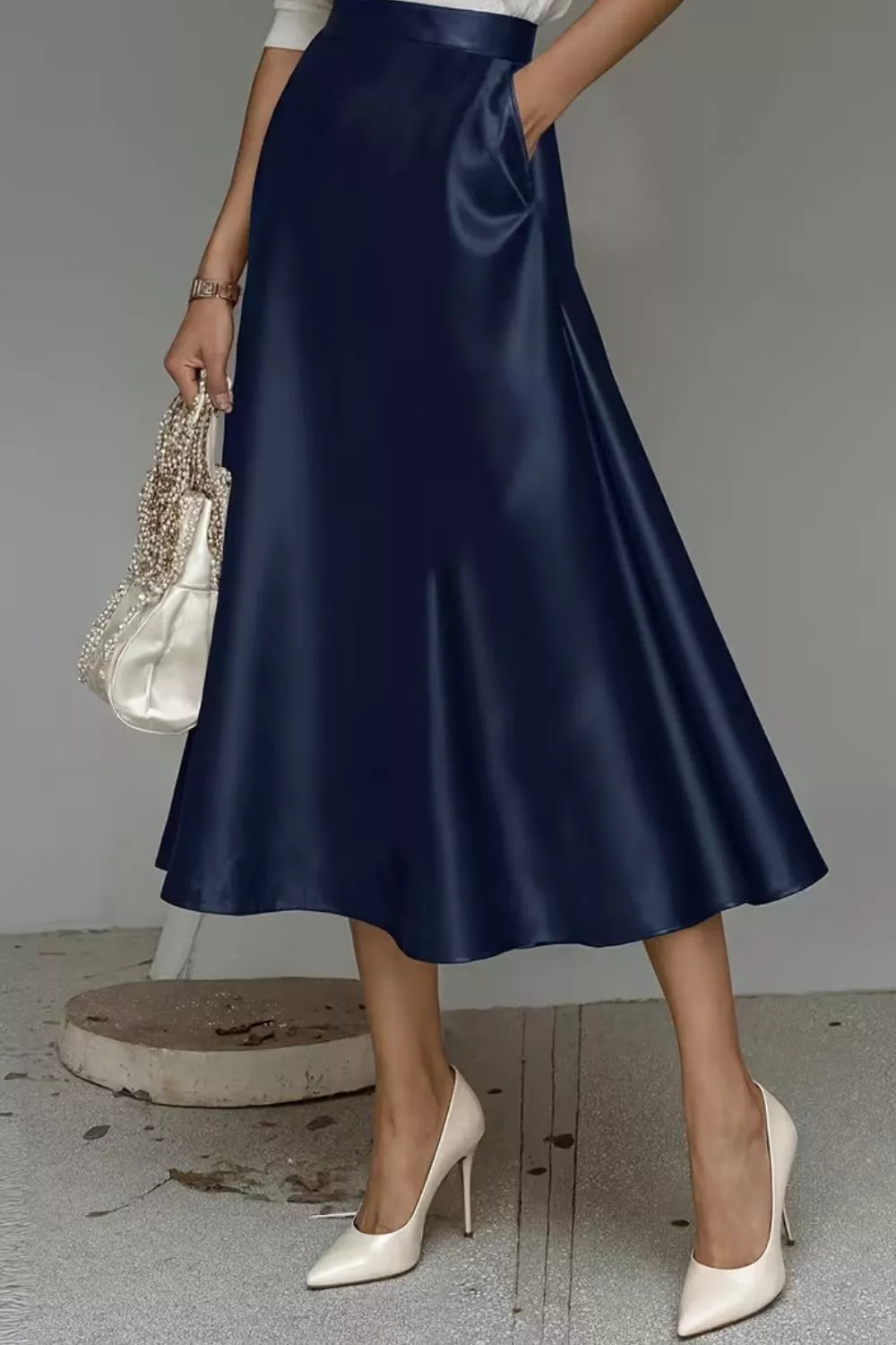Satin A-line midi skirt in navy with smooth sheen and side pockets