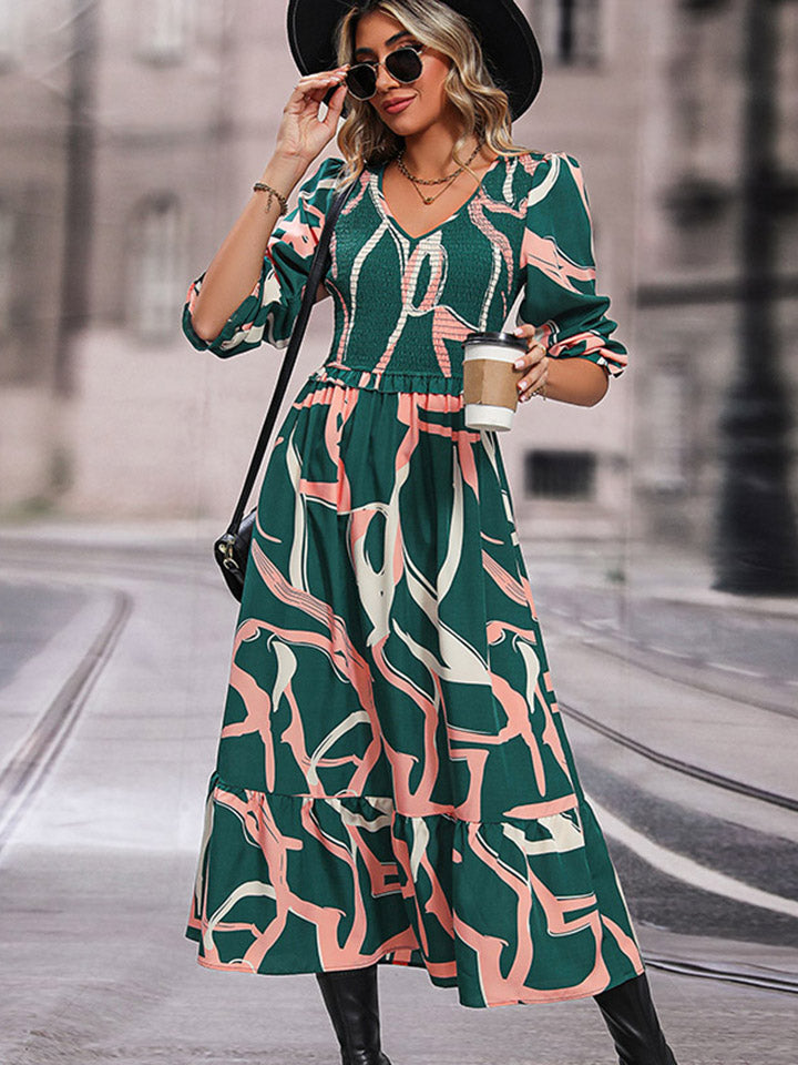 Mid green abstract print smocked V-neck midi dress with three-quarter sleeves and cinched waist