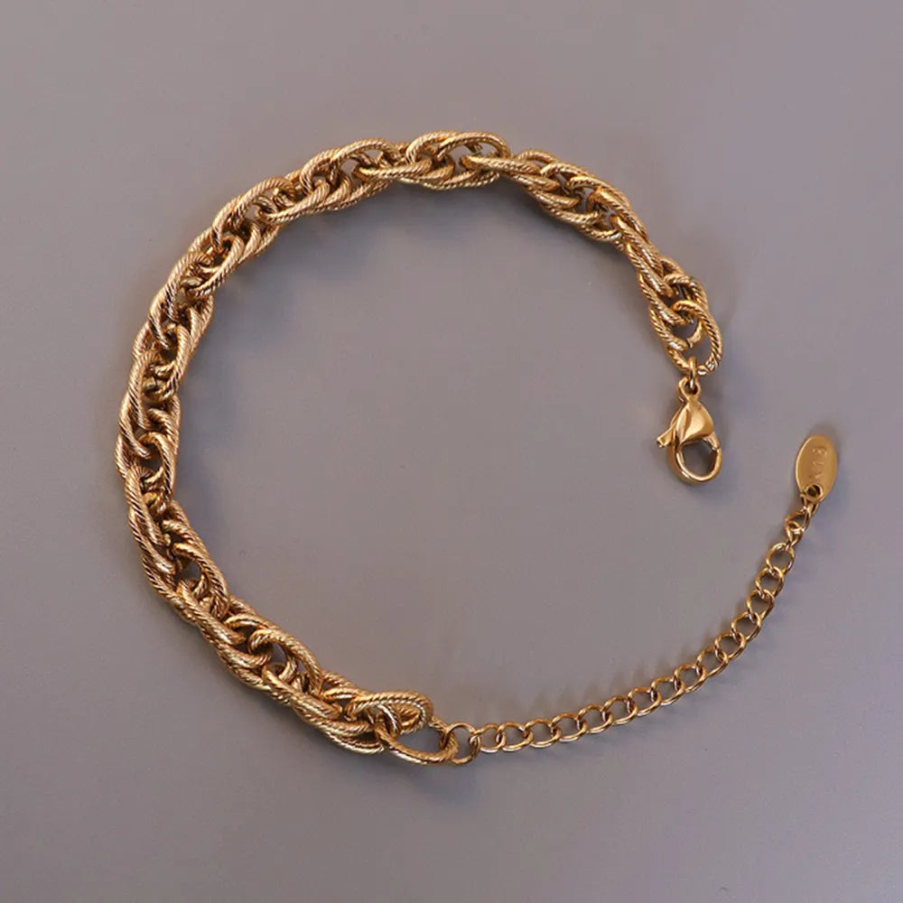 Gold chain bracelet close-up with lobster clasp and braided links