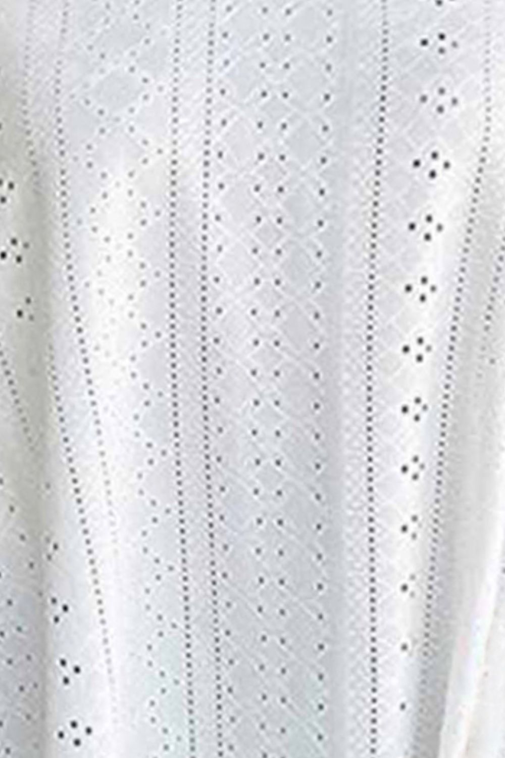 White eyelet fabric with punched motifs and vertical stripe rows on a cami.