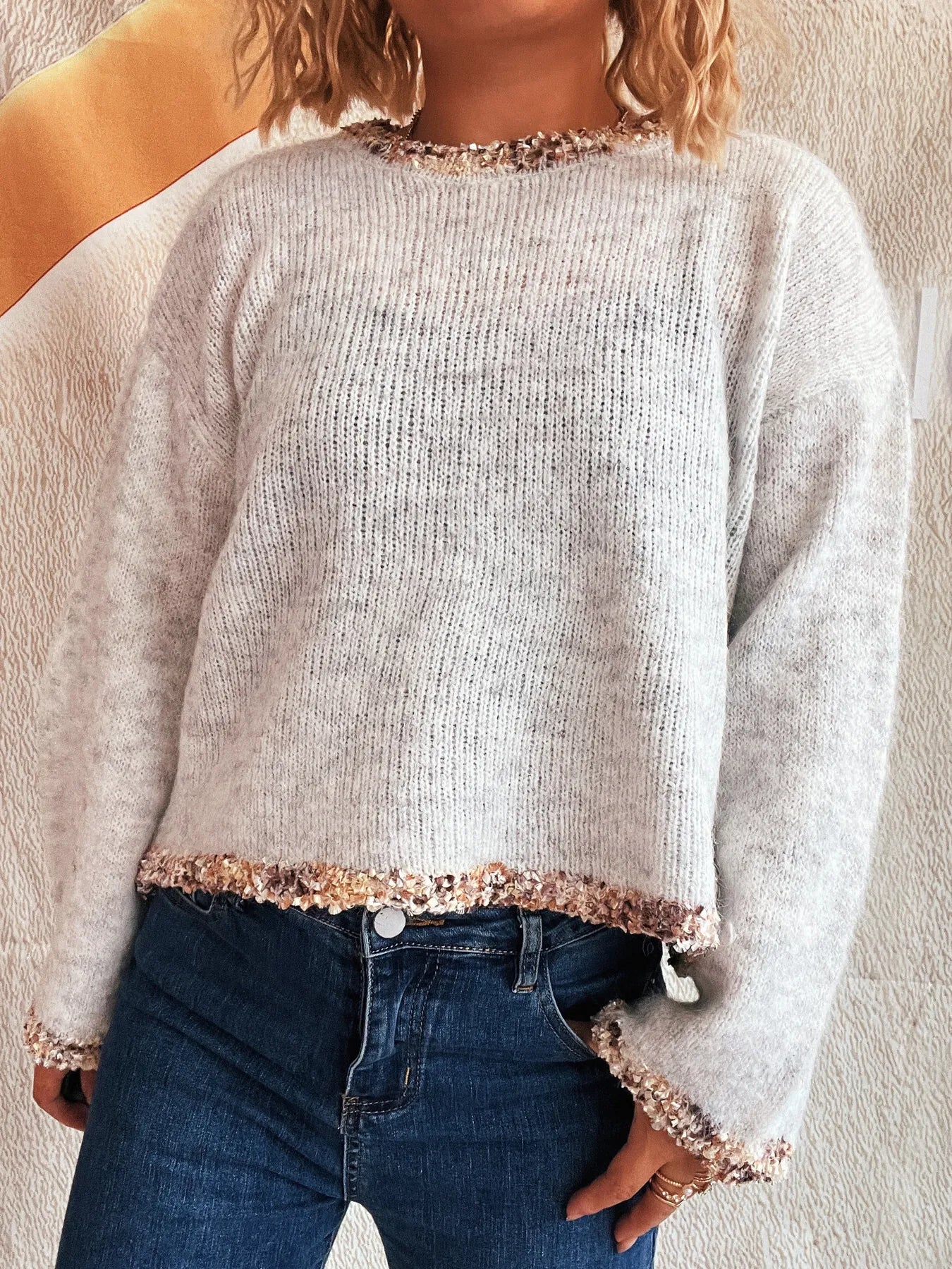 Light gray cropped round-neck sweater with sparkly knit trim along neckline and hem