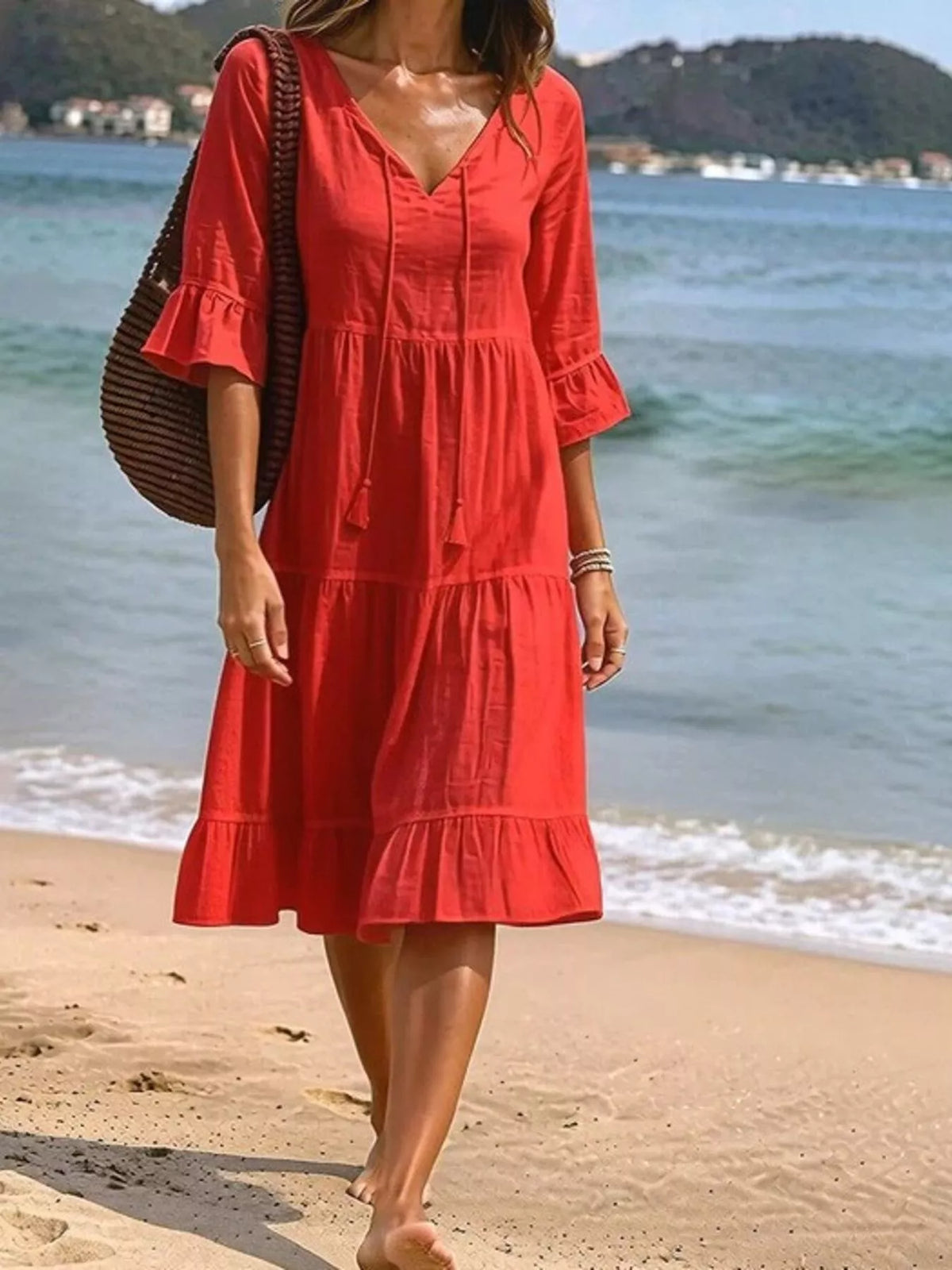 Red tiered tie-neck flounce sleeve dress with tassel strings, knee-length