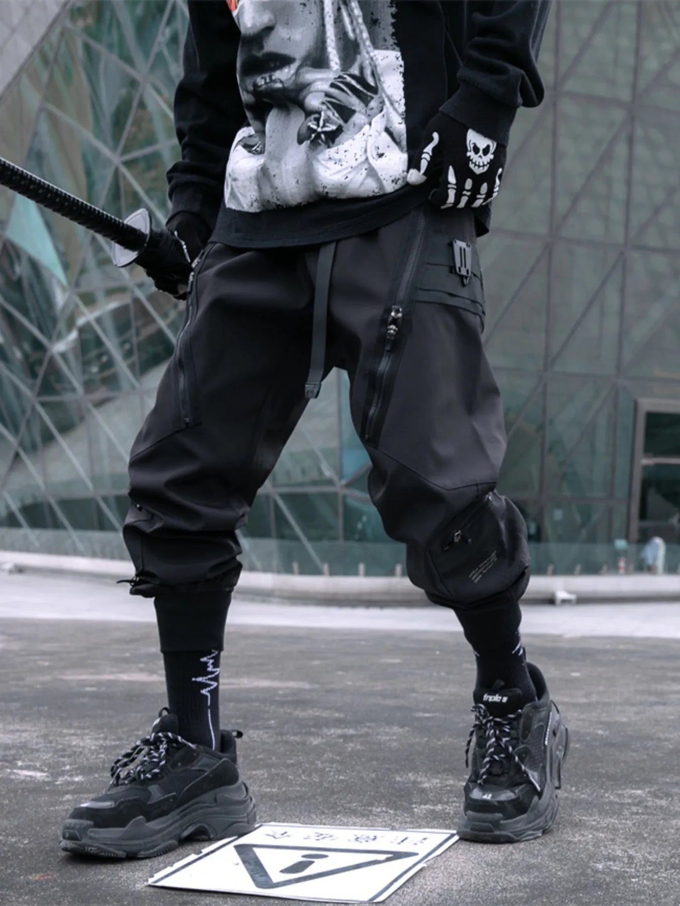 Black cargo joggers with layered pocket zips and cuffed ankle design