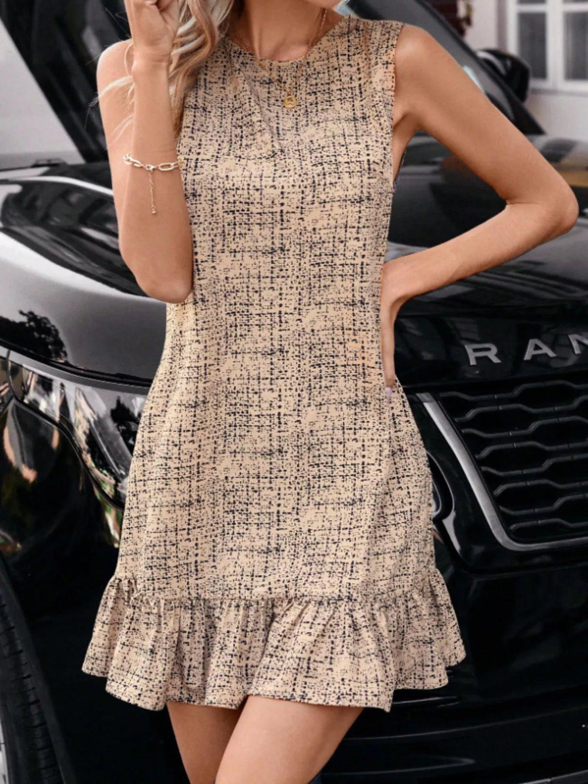 Sleeveless tweed mini dress with round neckline and ruffled hem, tan speckled