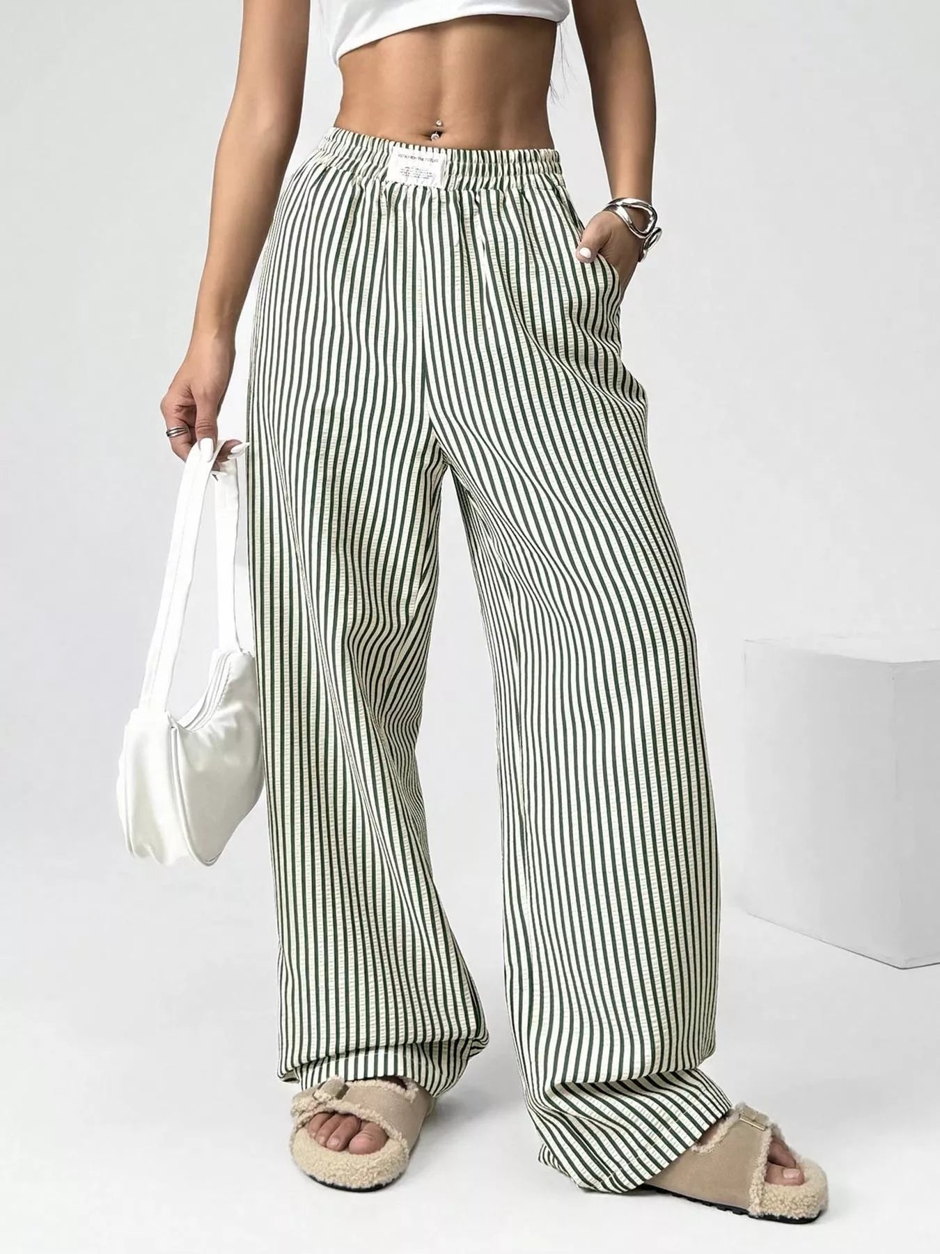 Women’s high-waist wide-leg pants with green-and-white vertical stripes, elastic waistband.
