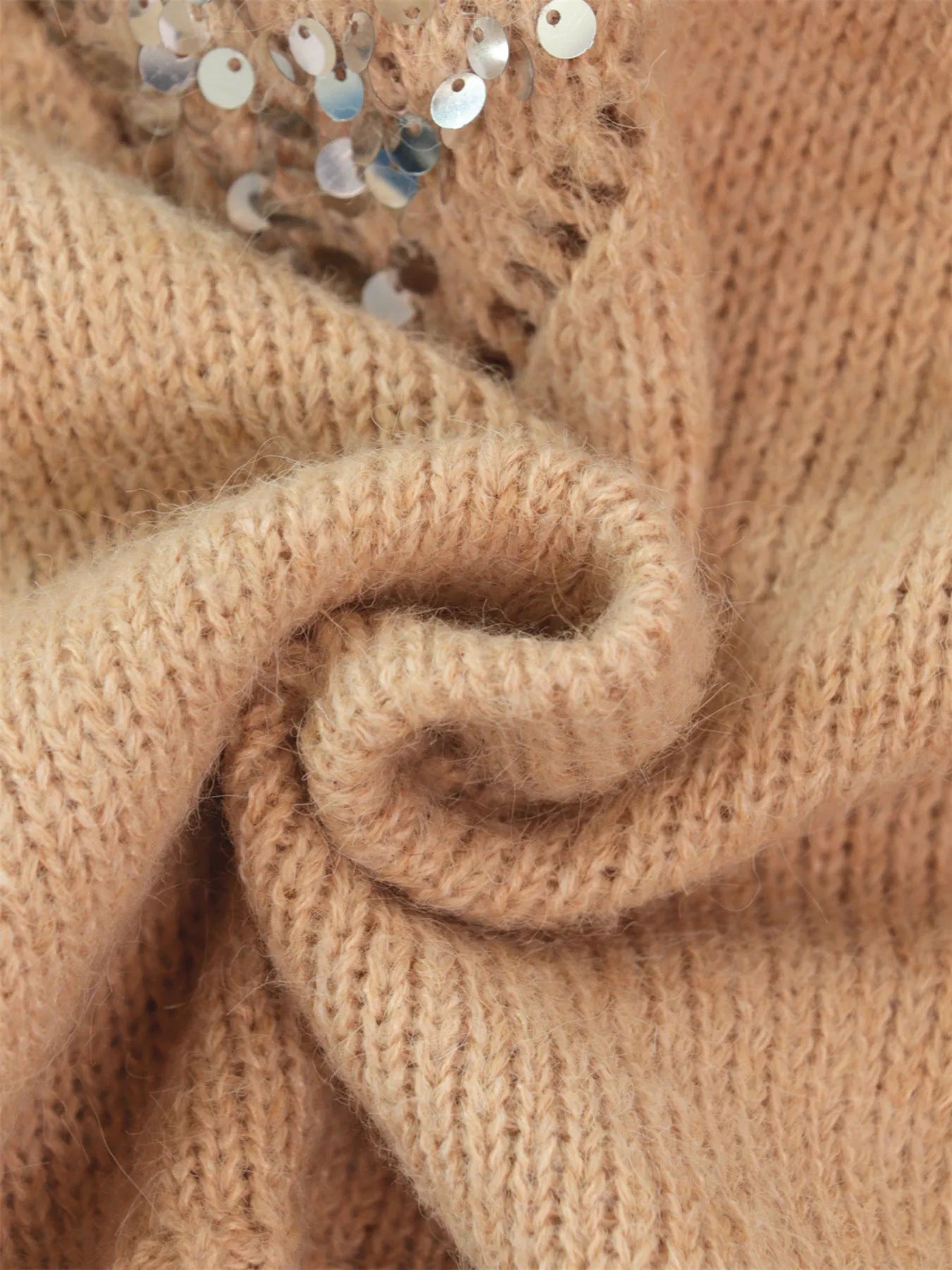 Khaki knit sweater fabric texture with sequins near the diamond motif