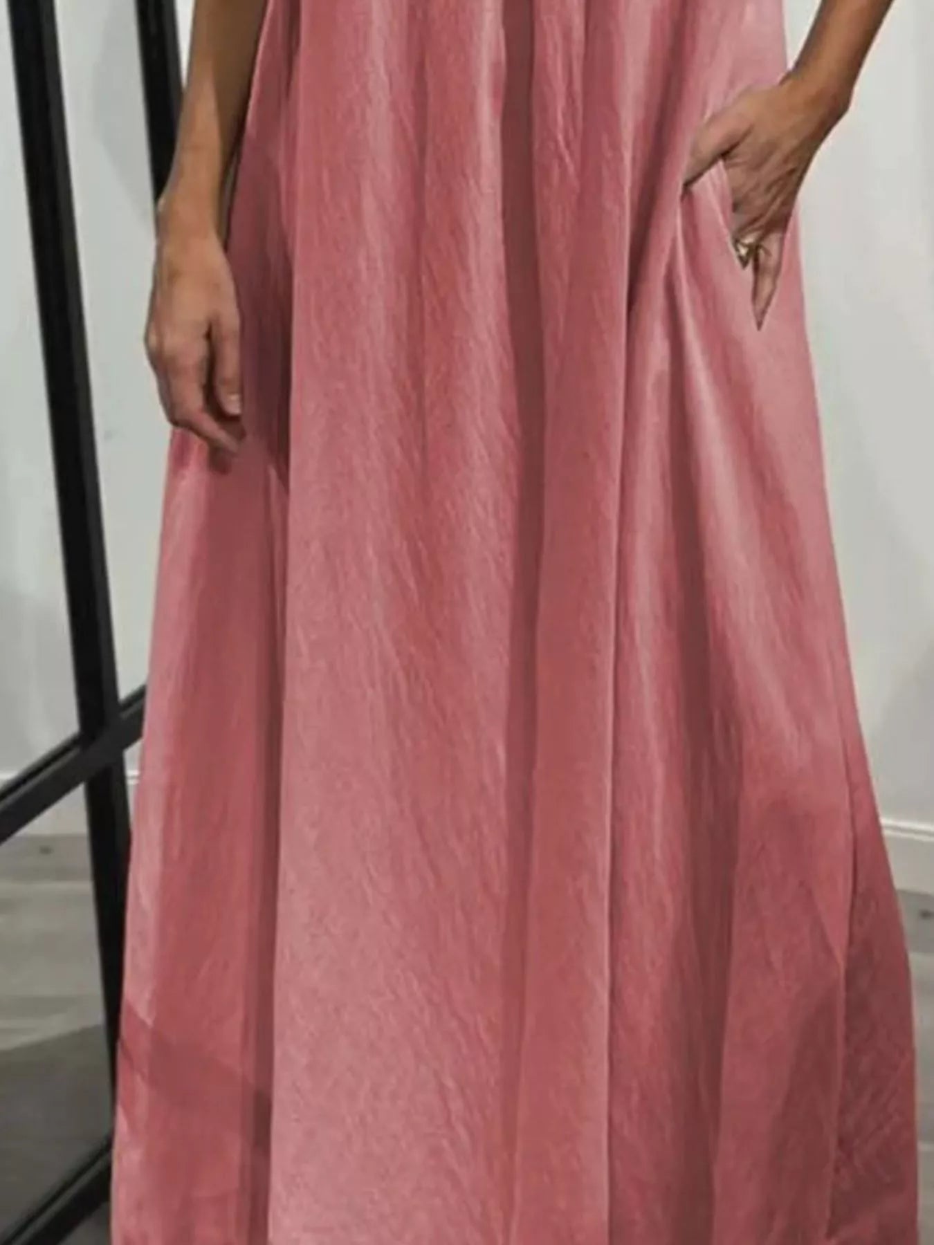 Plus-size pink maxi dress with pockets and ruffles, flowy fabric
