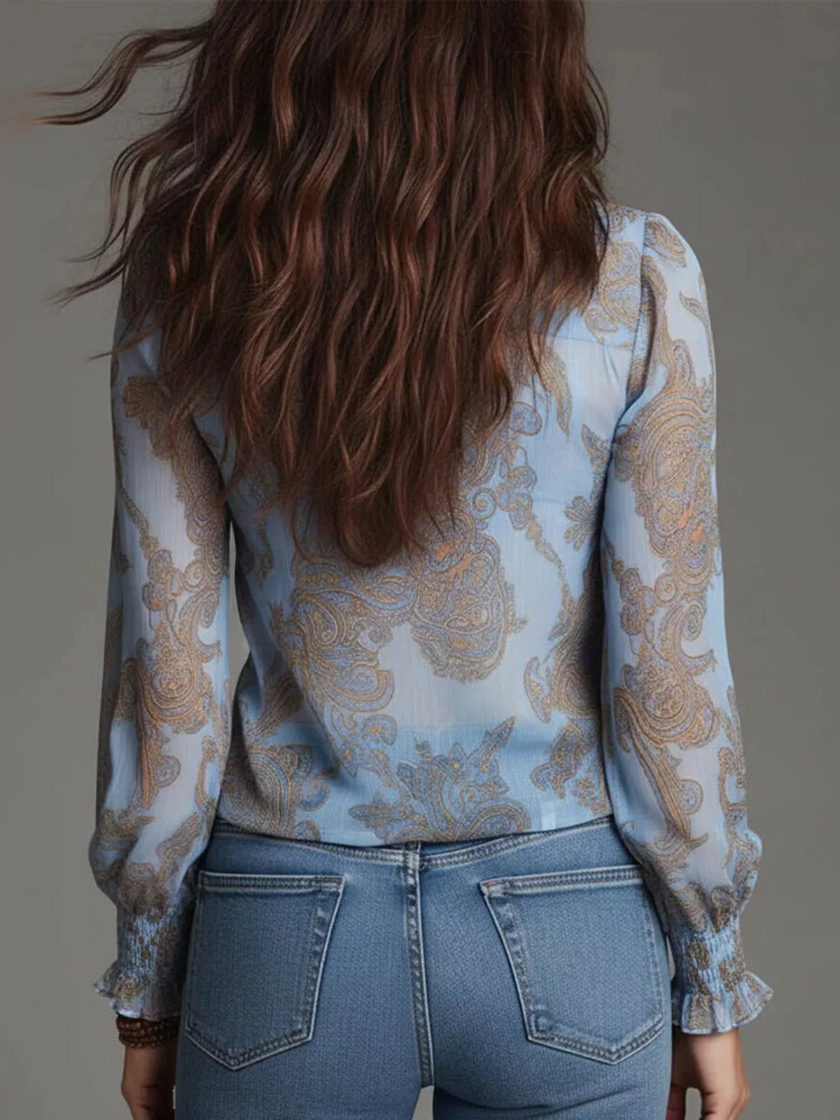 Sky blue paisley ruffle zip-front blouse with long sleeves and gathered cuffs