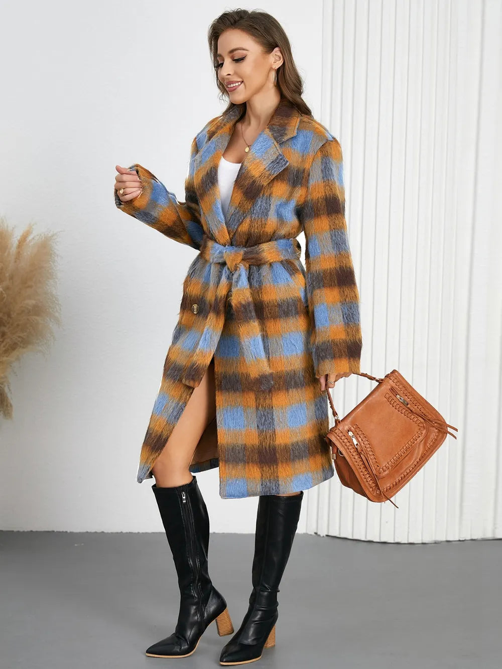 Plaid collared neck coat with waist tie belt and long sleeves, worn with boots.