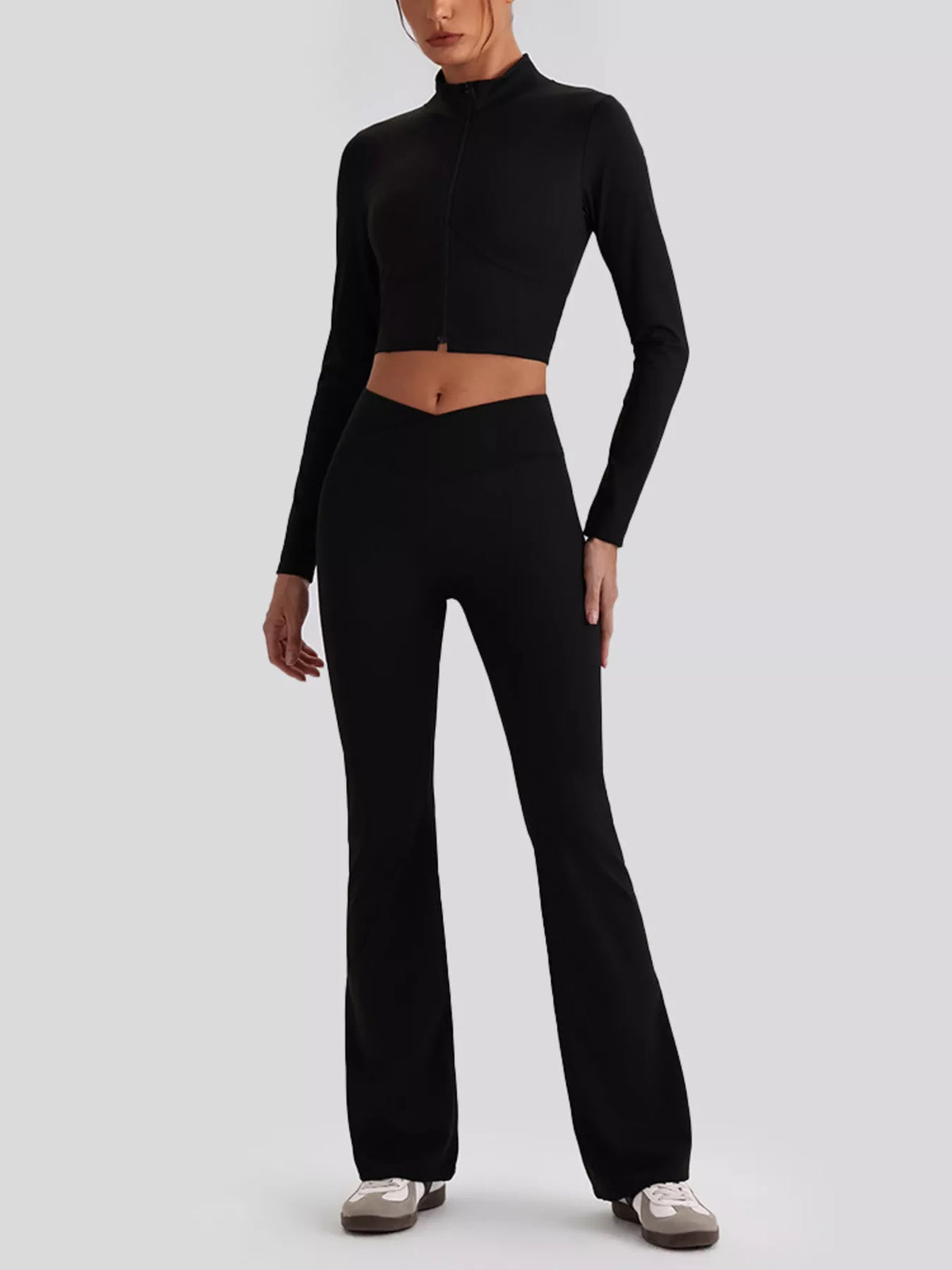 Black V-neck crop top and flared-leg leggings set, full-body view