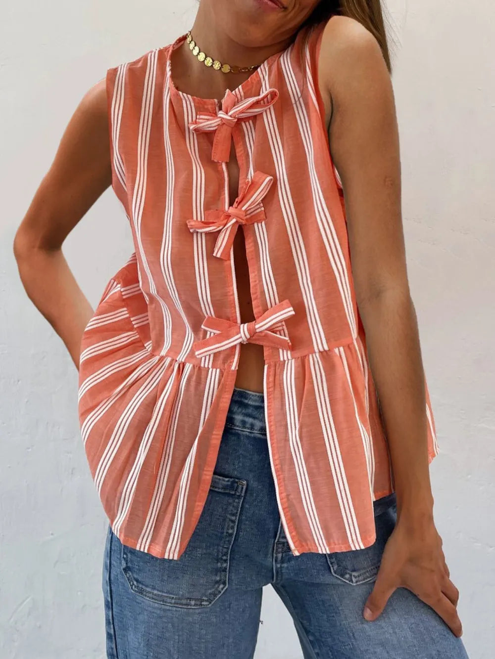 Orange striped sleeveless tank top with bow-tie neckline and front ties