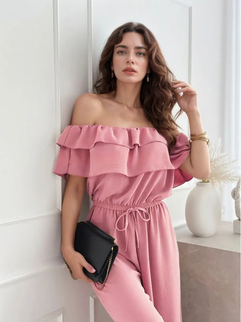 Dusty pink off-shoulder ruffled wide-leg jumpsuit with layered neckline and drawstring
