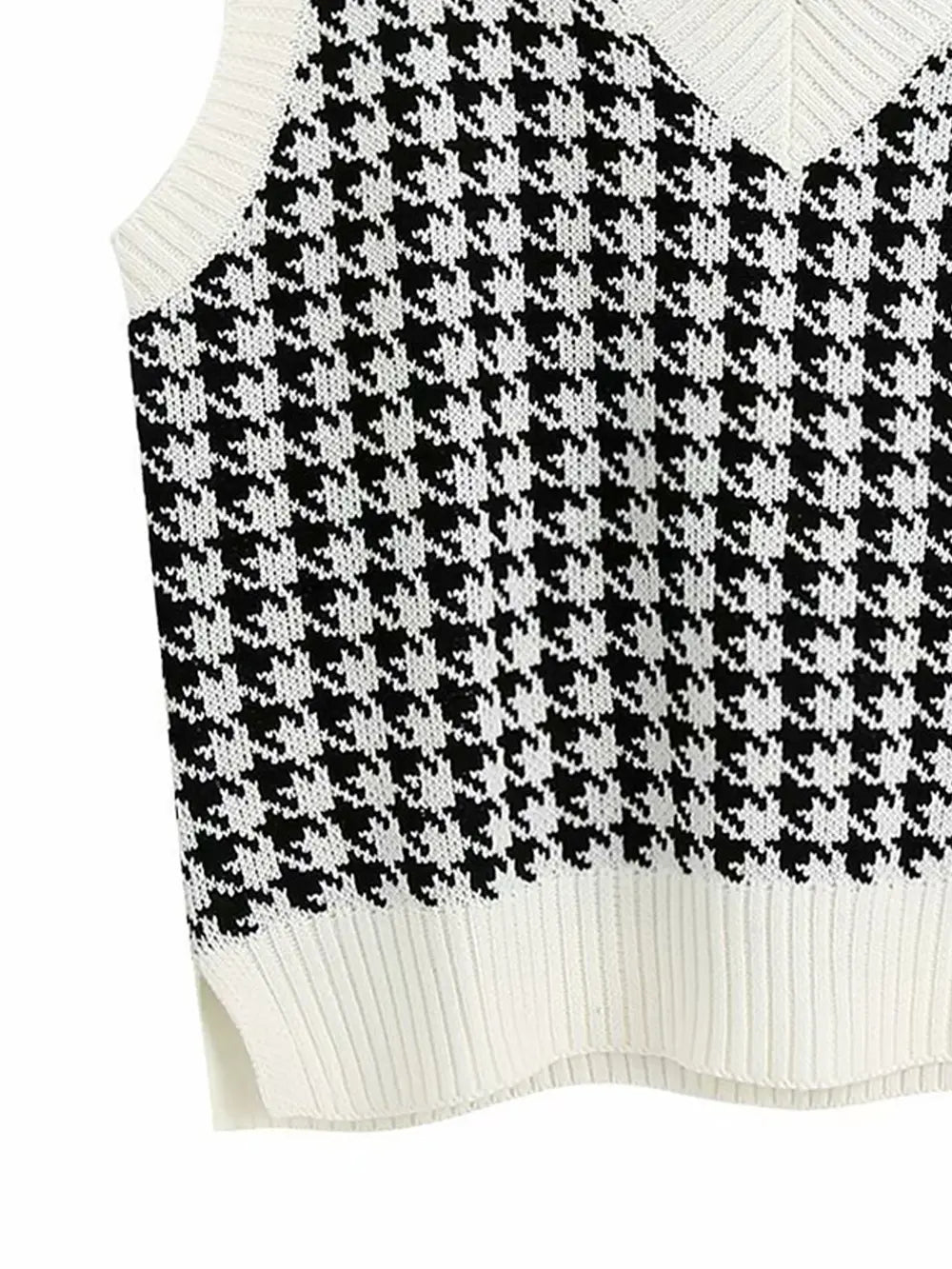 Black and white houndstooth knit sweater vest with ribbed hem and sleeveless cut