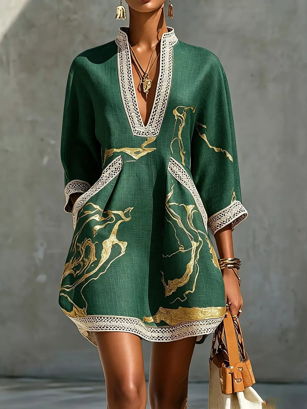 Green relaxed-fit mini dress with notched V neckline, lace trim, and gold horse-print accents