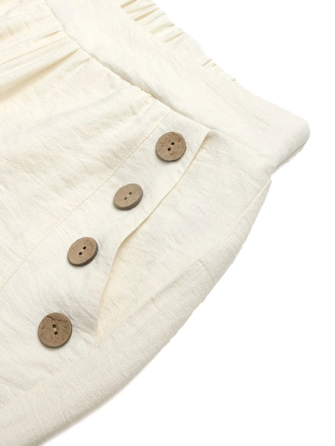 Cream textured fabric with round buttons on wide-leg pants