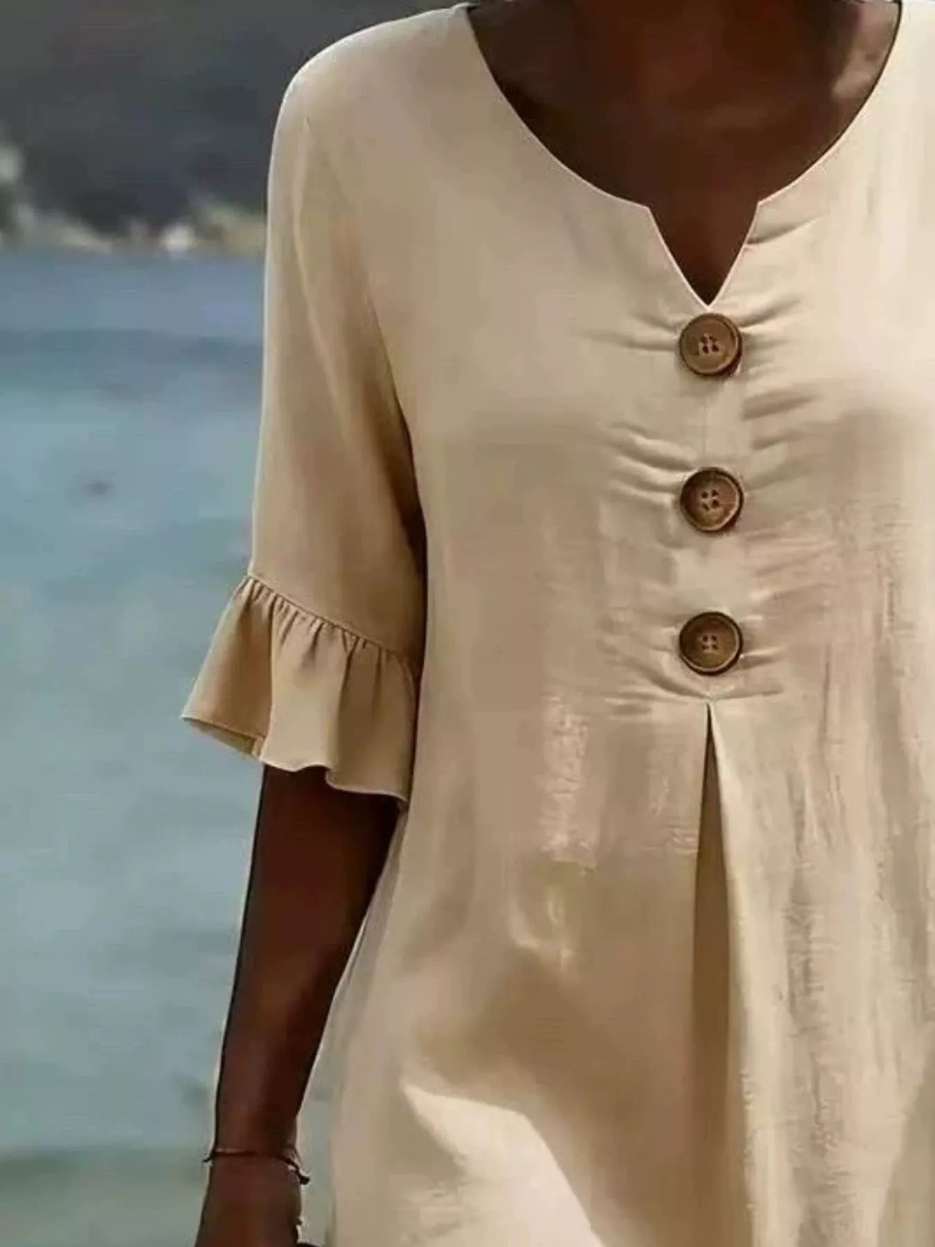 Cream button-front dress, V-neck and three wood-look buttons, ruffle cuff sleeves