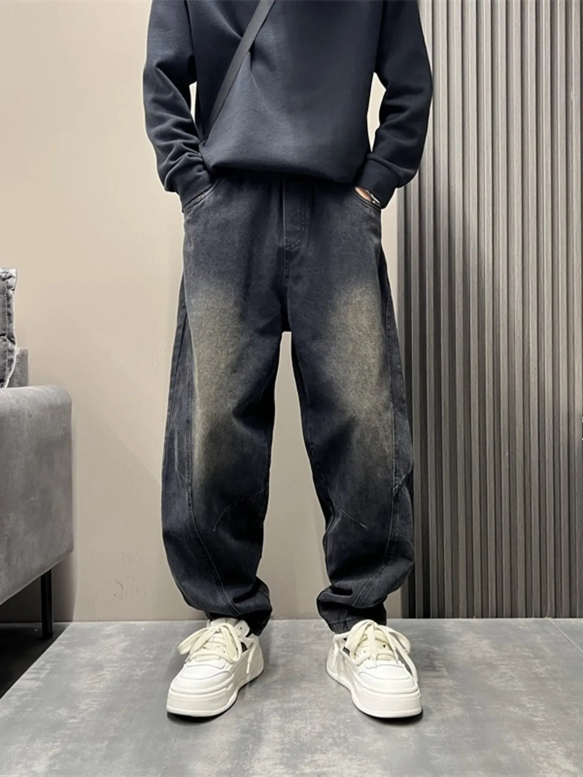 Washed black loose-fit stretch jeans with gathered ankle cuffs and side pockets
