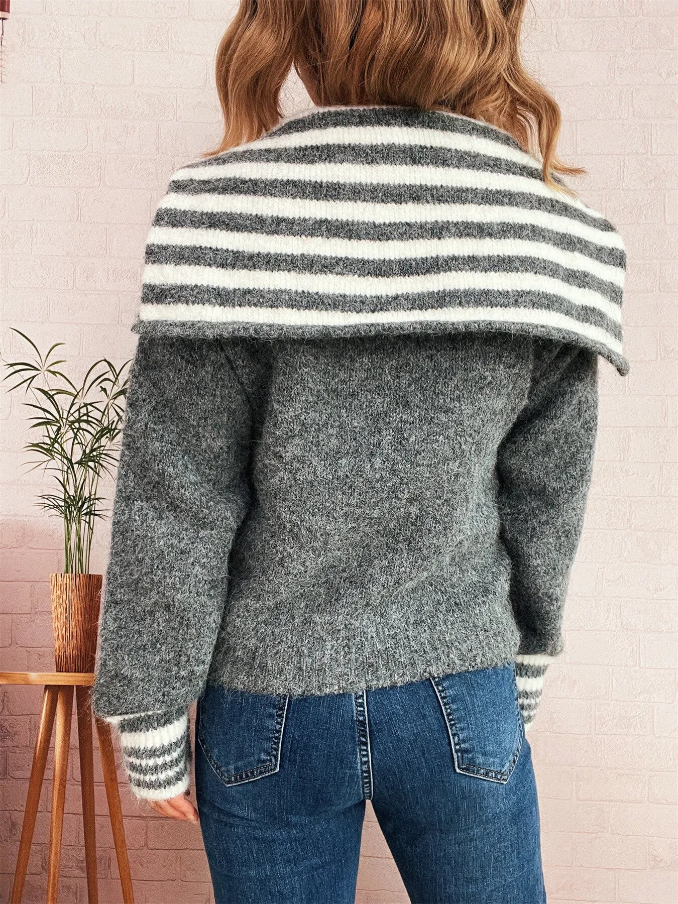 Back view of gray zip-up cardigan with striped hood and ribbed hem cuffs