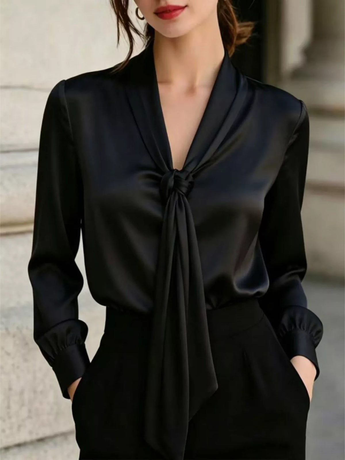 Black satin blouse with V-neck and front tie, long sleeves