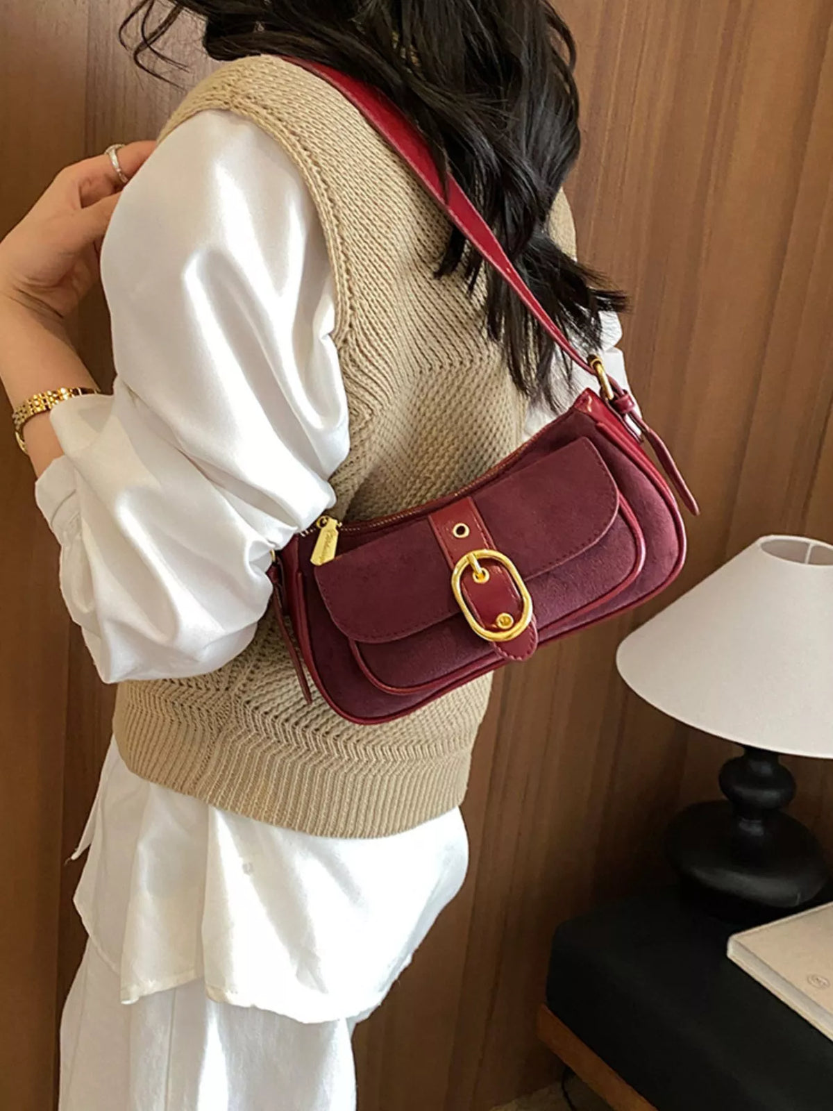 Wine red suede mini shoulder bag with flap, buckle clasp, and crossbody strap