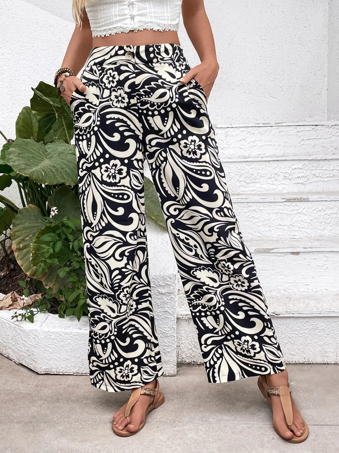 Wide-leg pants in black and white ornate paisley floral print, wide straight silhouette