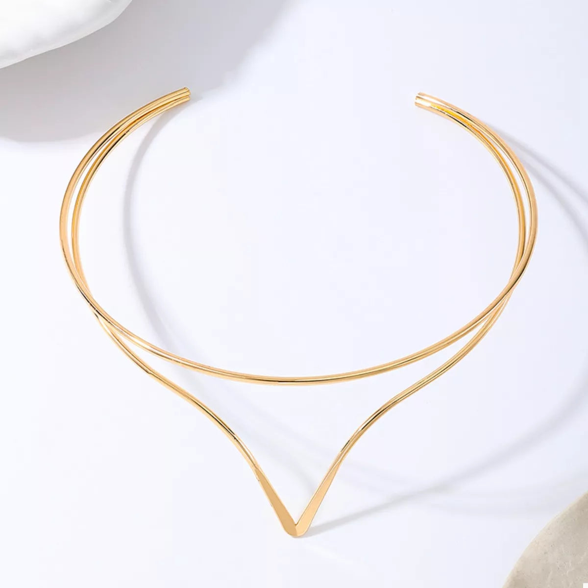 Gold double-layer V-shaped choker necklace, flat lay with V centerpiece