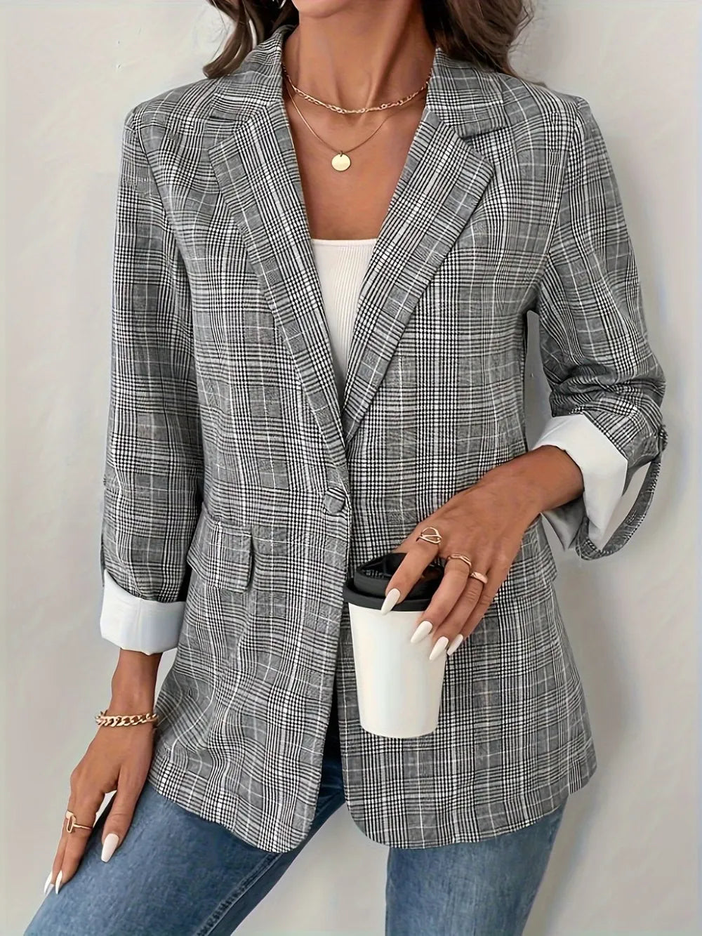 Light gray plaid blazer front with notched lapel and two-button closure