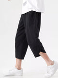 Black loose-fit cropped harem pants with drop-crotch drape and wide cuffs