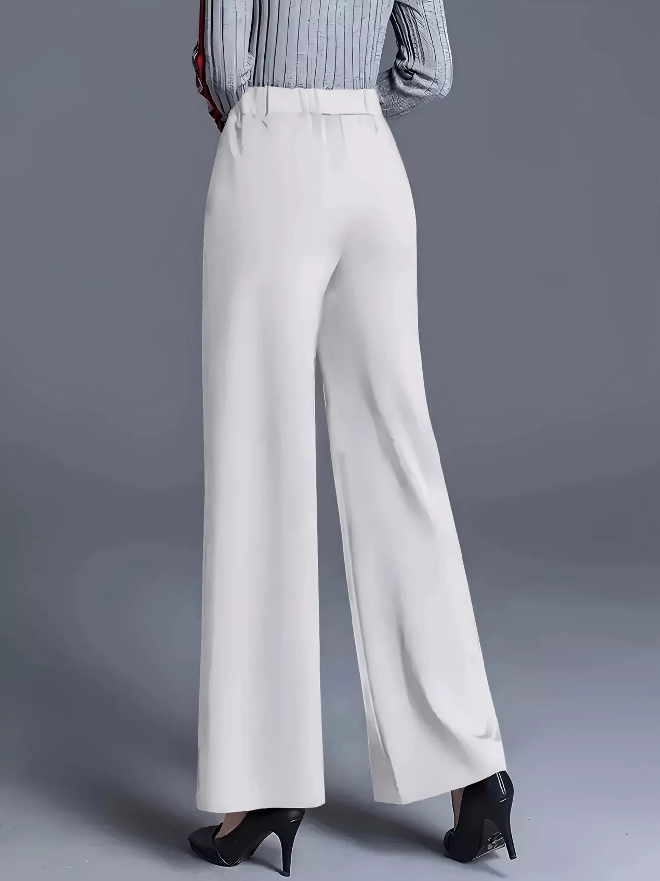White high-waisted wide-leg pants with a front crease and relaxed straight legs