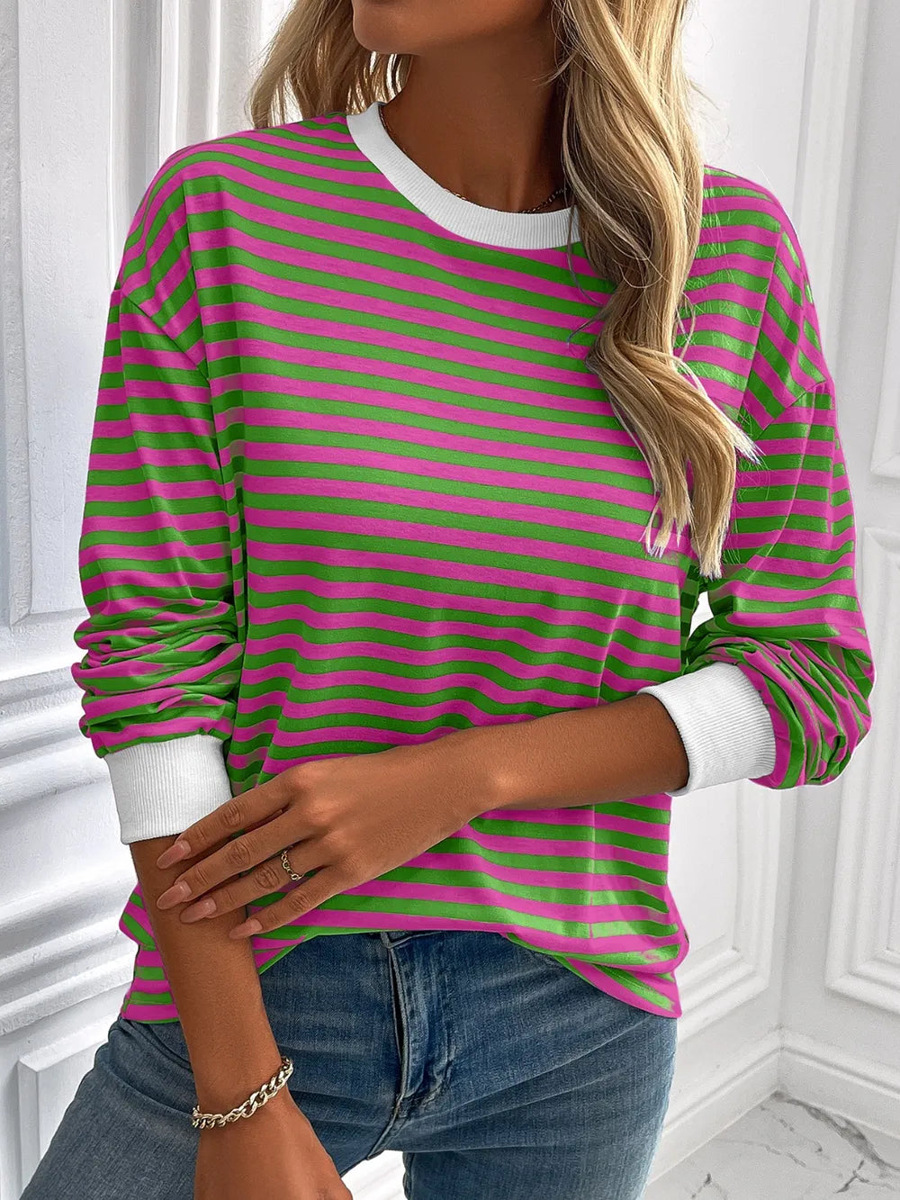Green and pink striped round-neck sweatshirt with long sleeves and white ribbed trim
