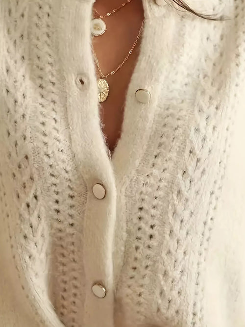 Cream eyelet cardigan front with round buttons and vertical textured knit panels
