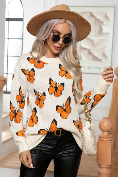 Ivory round-neck long-sleeve sweater with orange butterfly pattern, knit texture