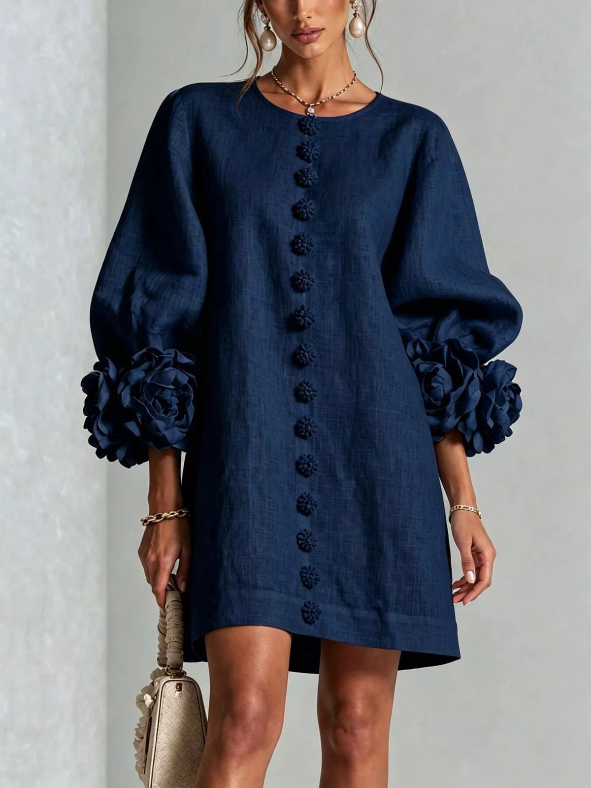 Navy mini dress with button-front detail and 3D floral appliques on puff quarter sleeves