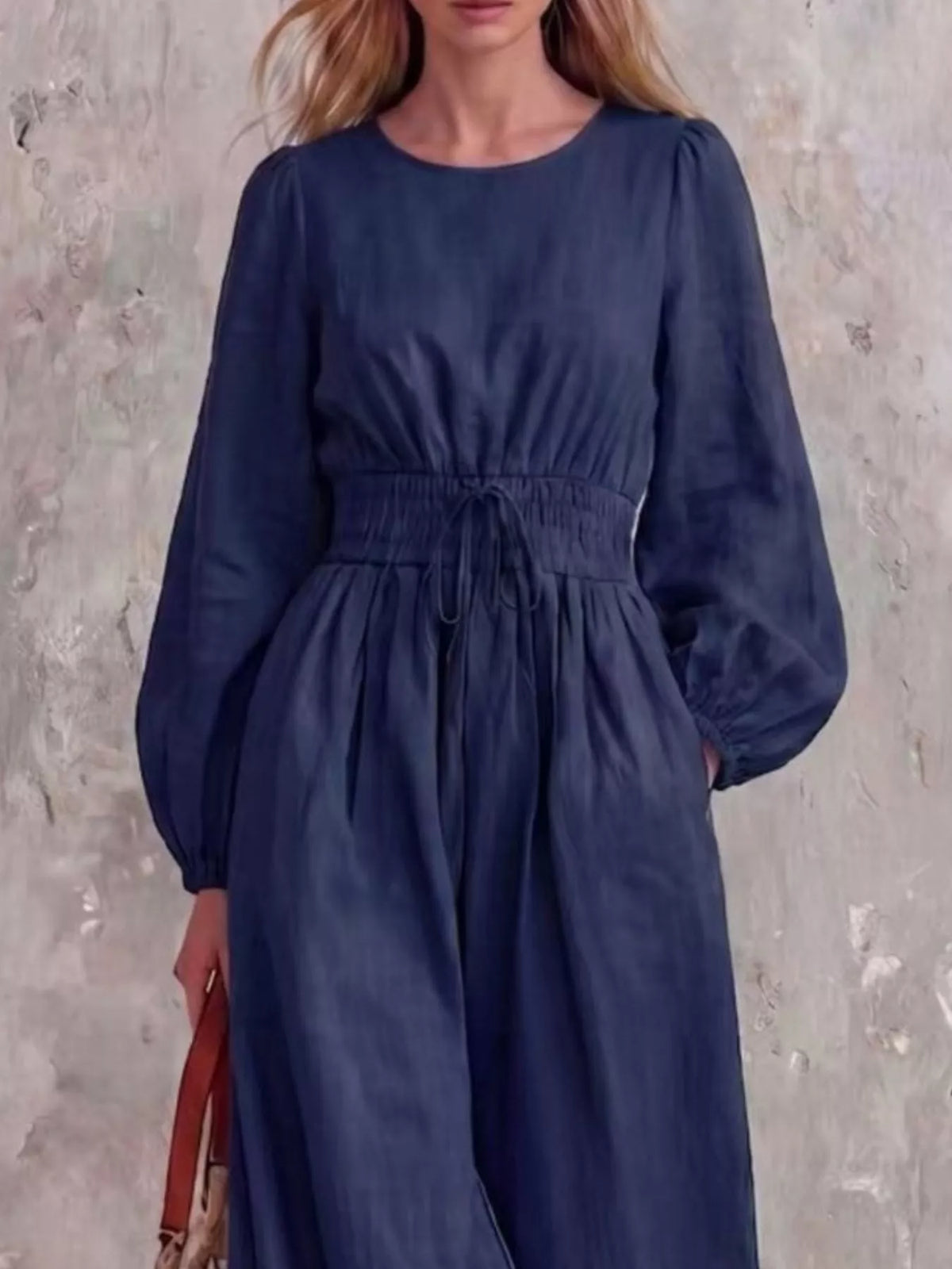 Smocked waist long-sleeve jumpsuit in dark blue with gathered skirt and drawstring