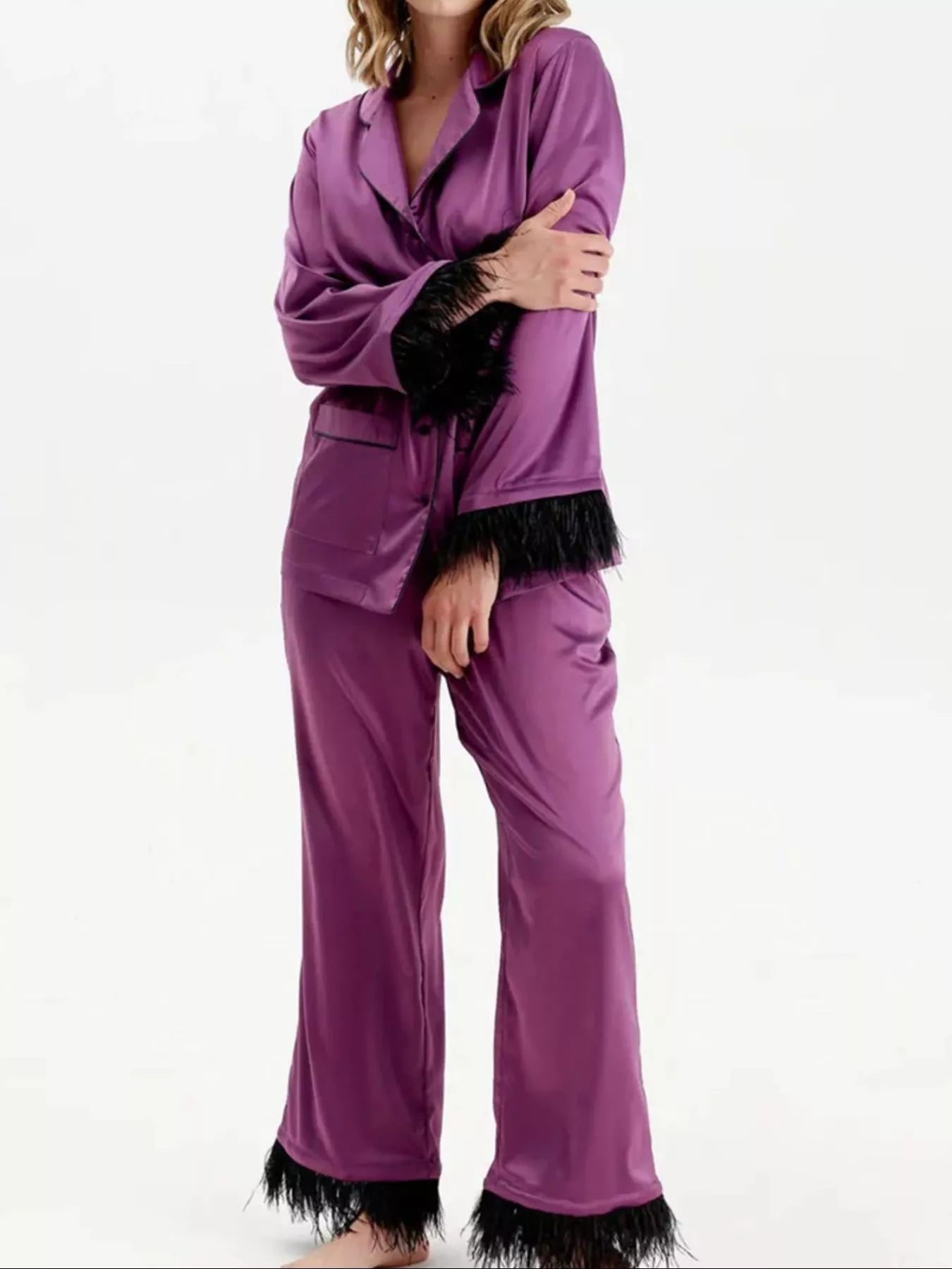 Silky lounge set in purple: button-up top and flared pants with black feather trim