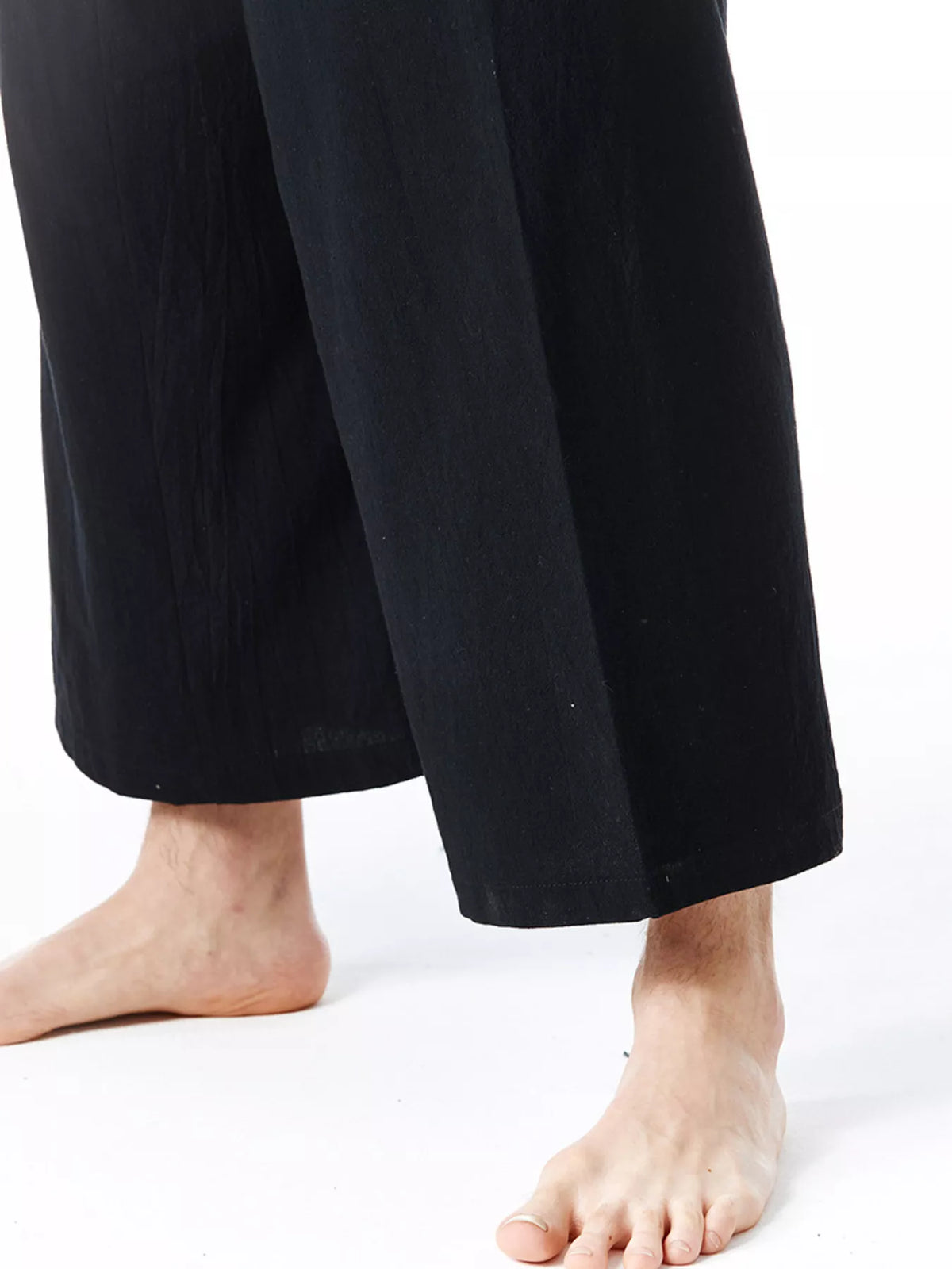 Black wide-leg drawstring pants with straight hem and stitched seams
