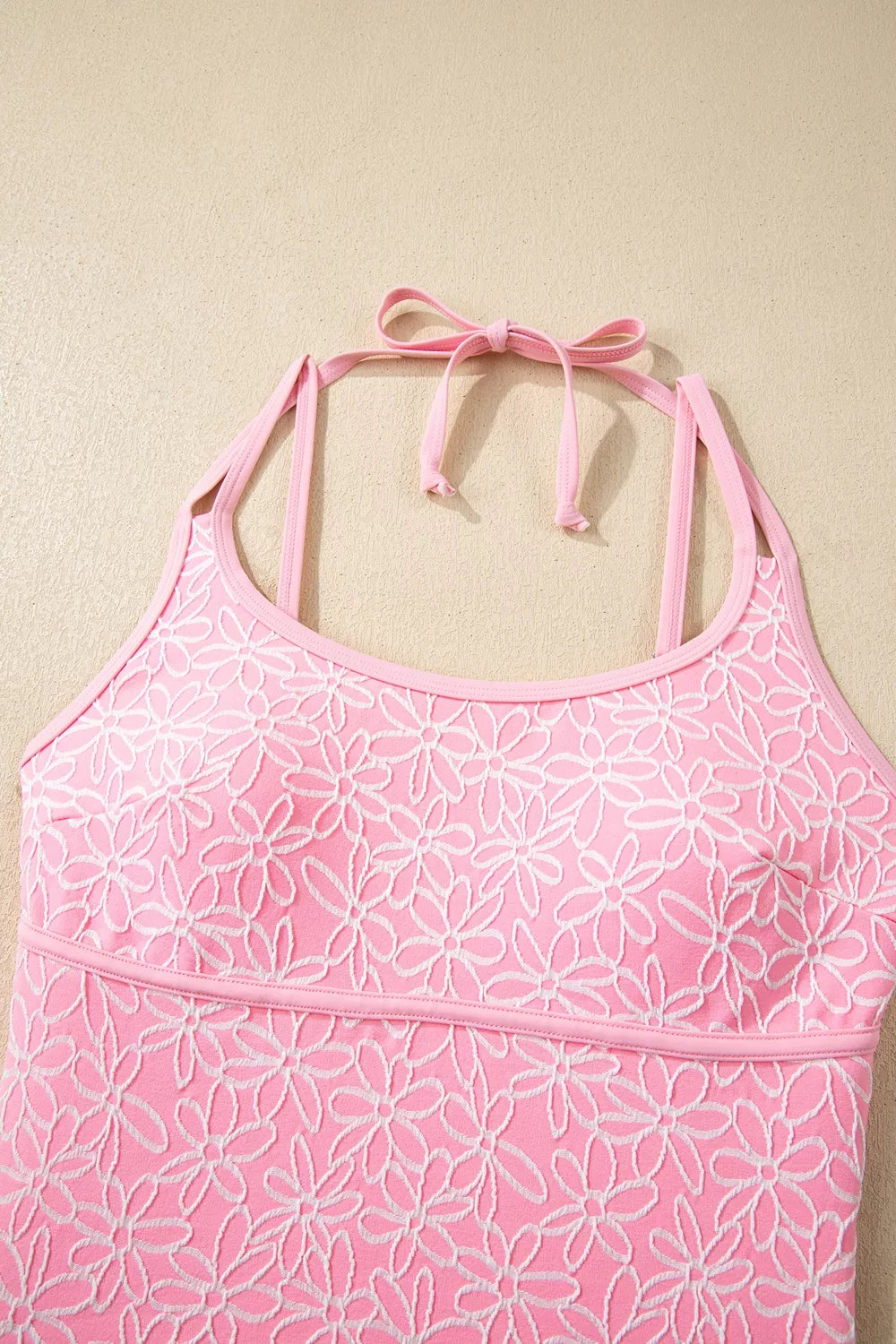 Blush pink floral halter one-piece swimsuit front panel with scoop neckline and strap seams