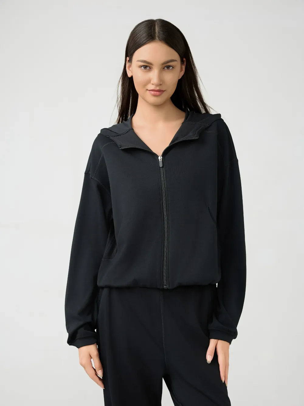 Black zip-up hooded active jacket with dropped shoulders and long sleeves