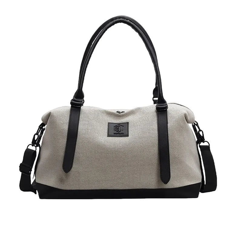 Large polyester duffle bag in cream with black contrast handles and front logo patch