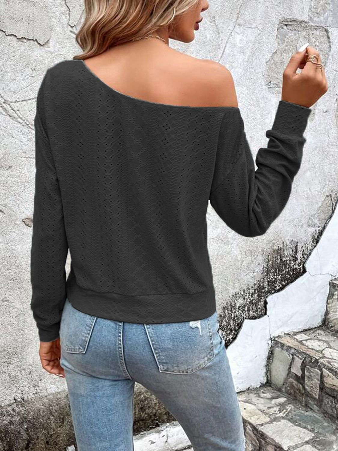 Black eyelet dropped-shoulder blouse with long sleeves, back view