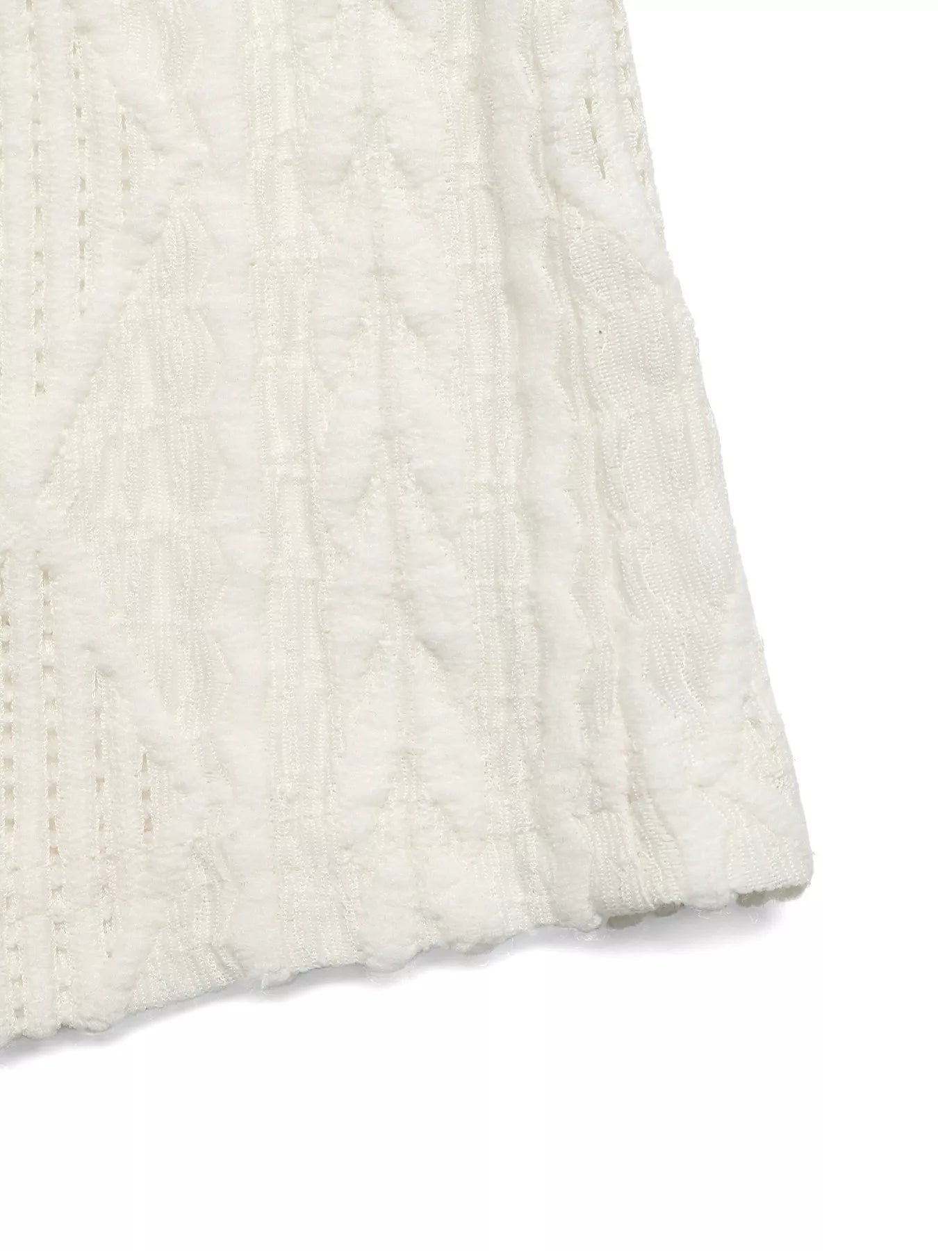 Cedar & Moore Textured Cap Sleeve Top in white fabric with raised pattern, close-up view of textured stitches and hem.