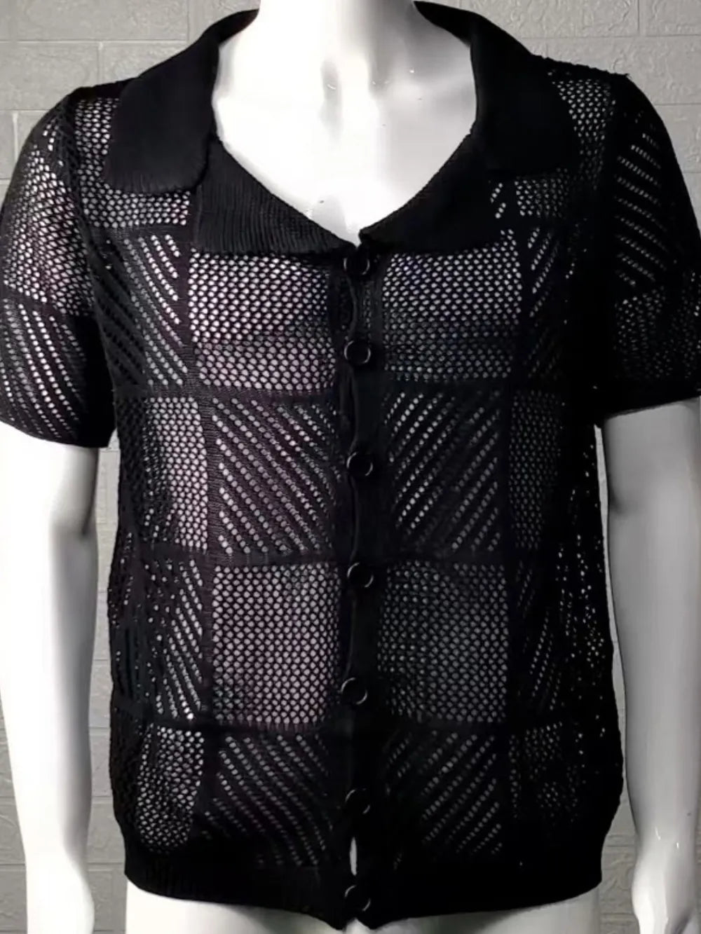 Black checkered eyelet button-down knit shirt with short sleeves and front buttons