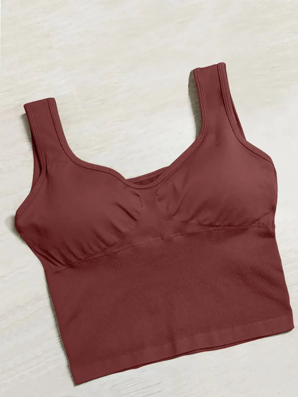 Active tank top in dark maroon with wide straps and scoop neck, gathered bust