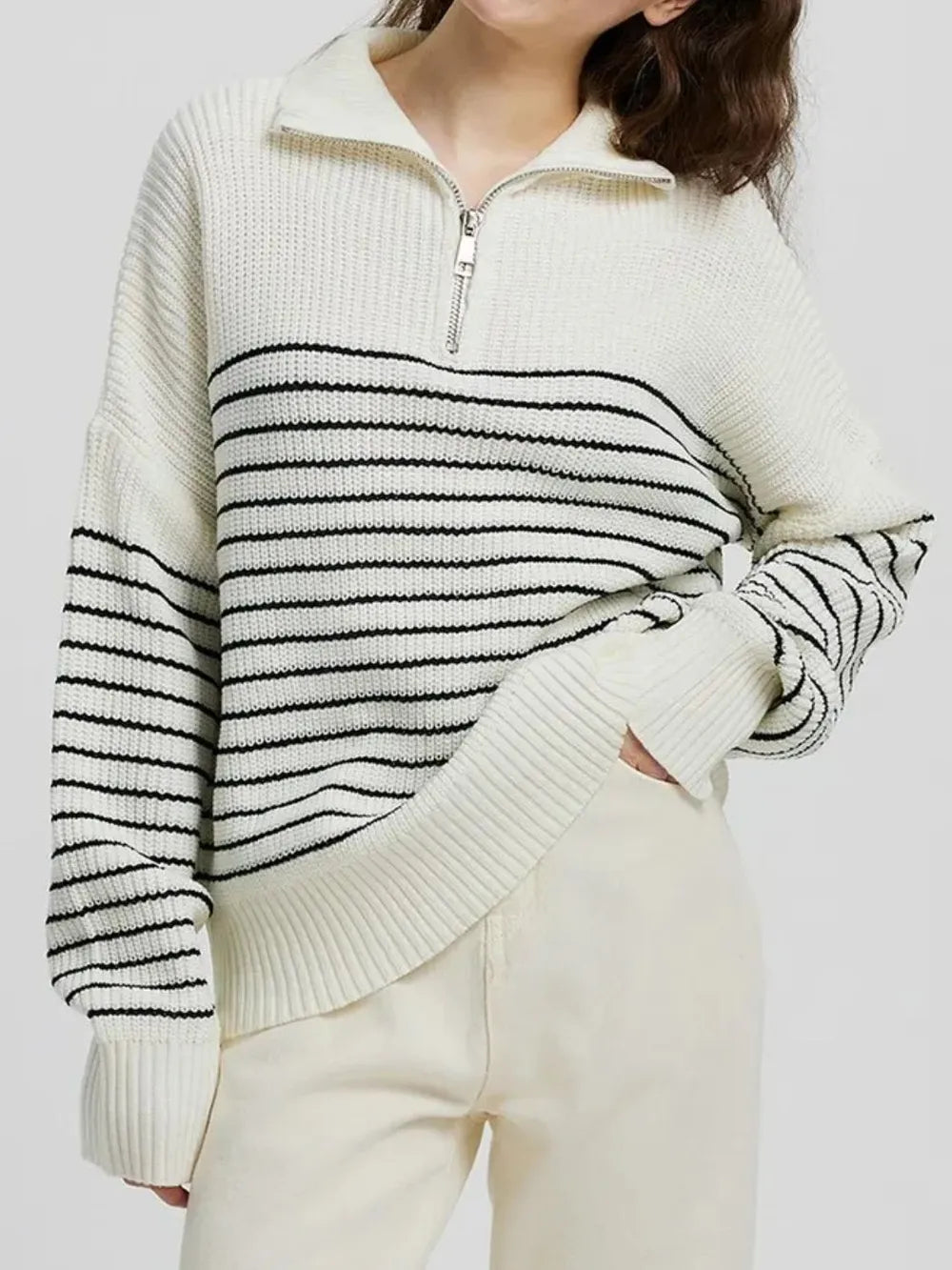 Cream striped half-zip knit sweater with long sleeves and ribbed cuffs, half-zip front