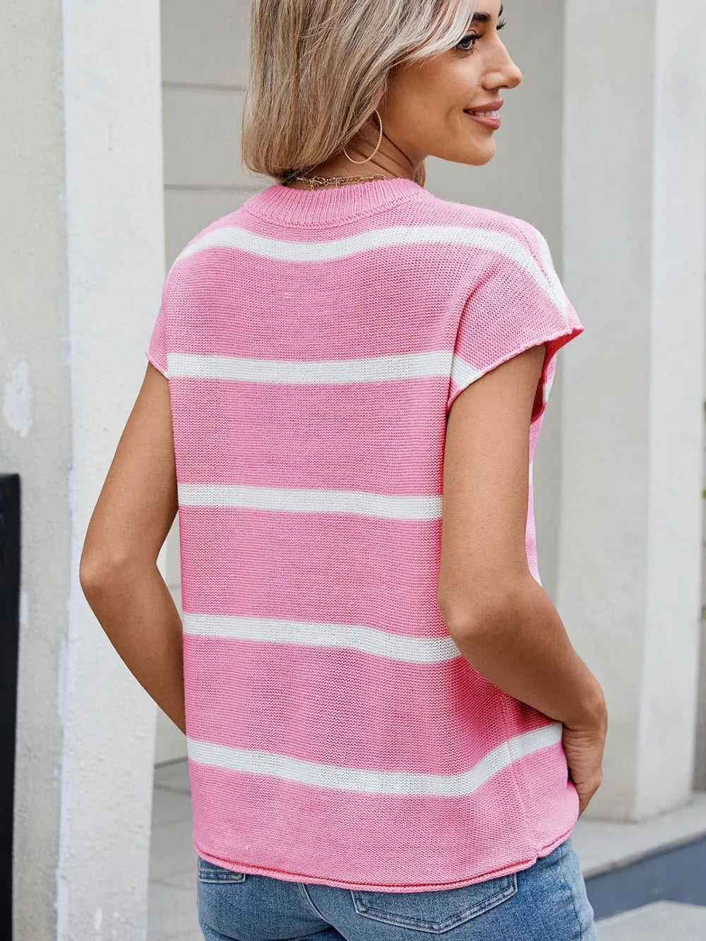 Pink striped knit top with exposed seam, round neck, short sleeve back view