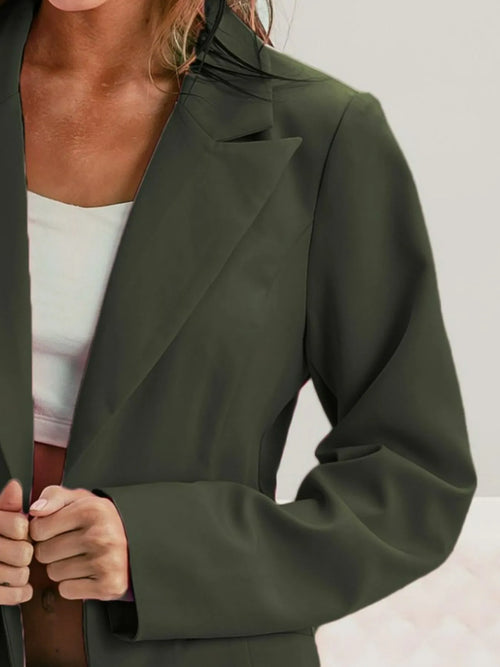 Olive blazer with peaked lapel, long sleeves, and structured shoulder seam