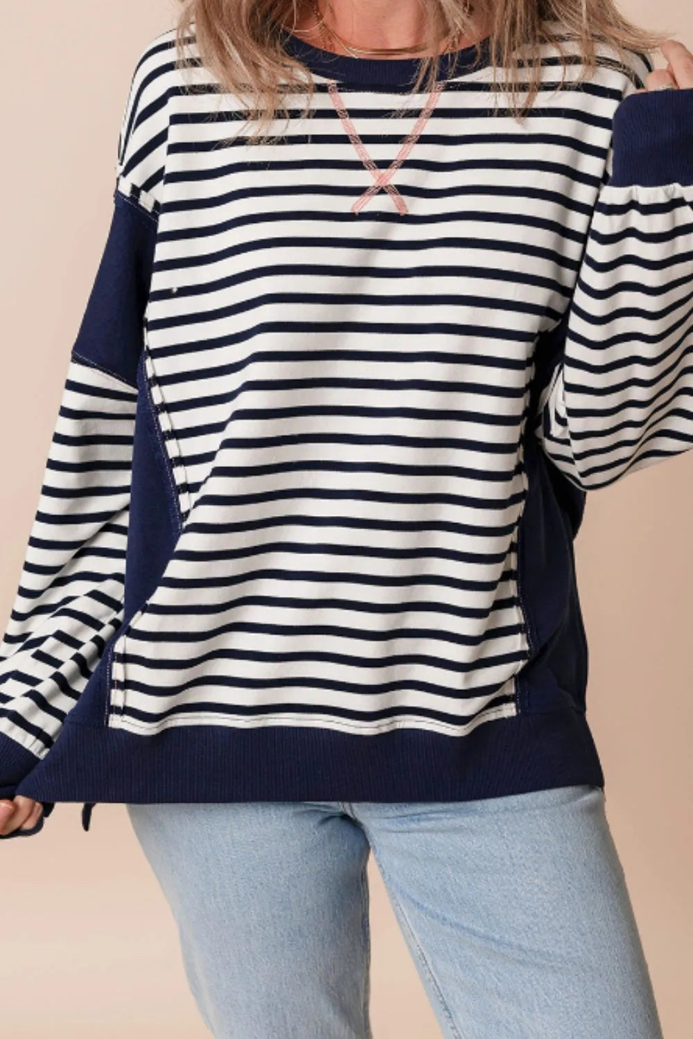 Striped long sleeve sweatshirt with exposed seam, navy and white stripes and crew neckline