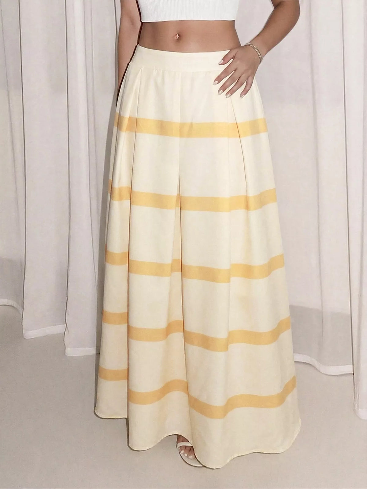 Yellow and white striped maxi skirt with elastic waist and side pockets
